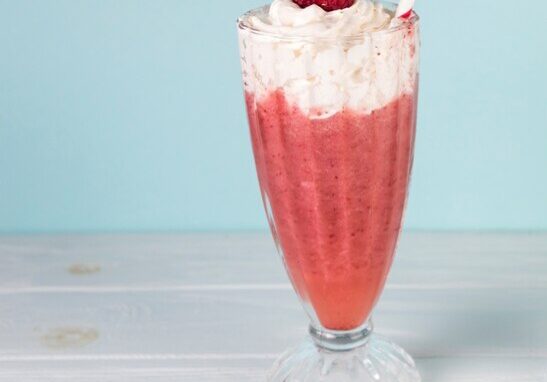 glasses-raspberry-milkshake-with-blue-background_23-2148037219